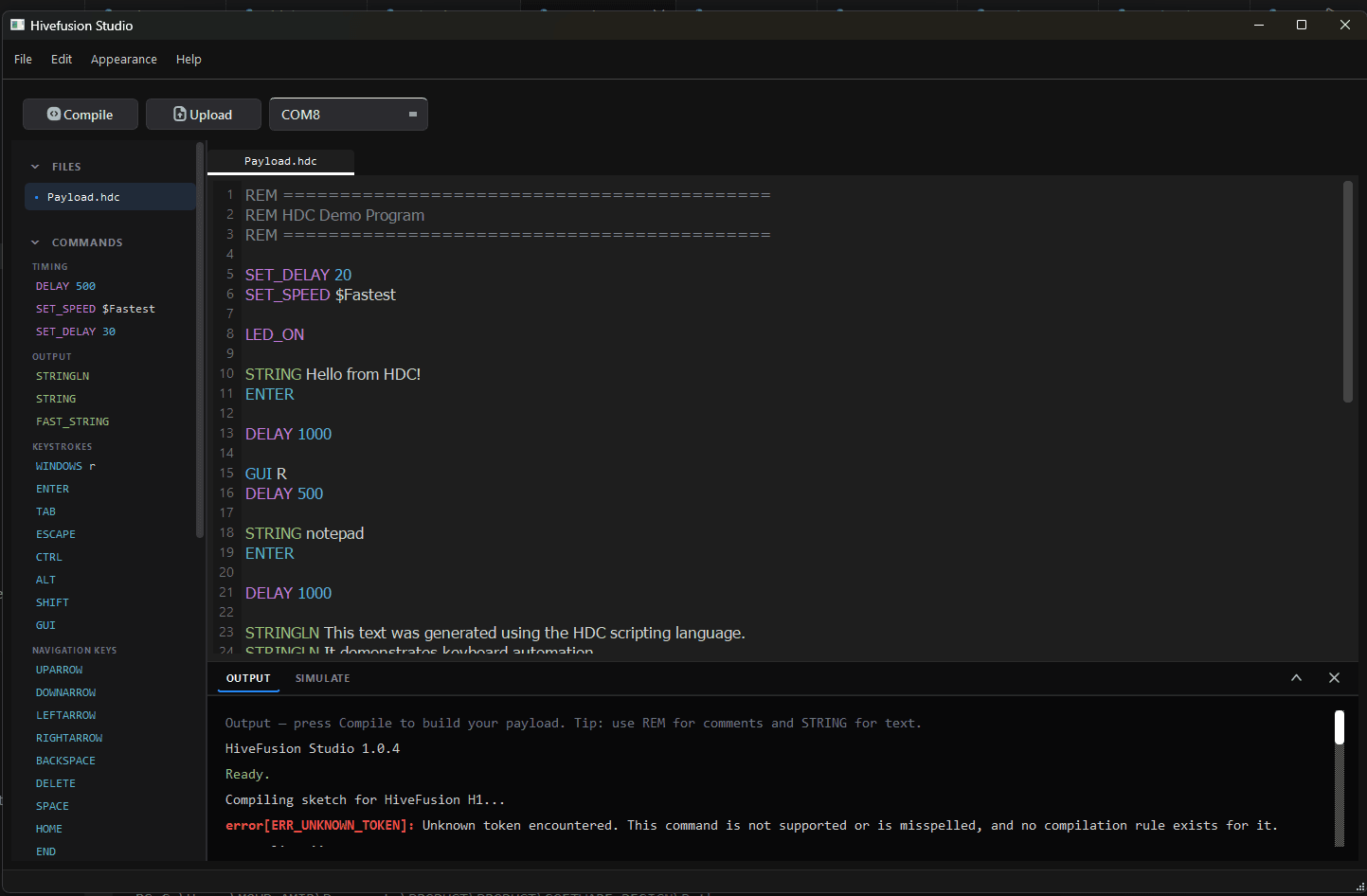 HiveFusion Studio with Payload.hdc open: an HDC command reference in the sidebar, the demo payload in the editor, and the compiler output panel below.